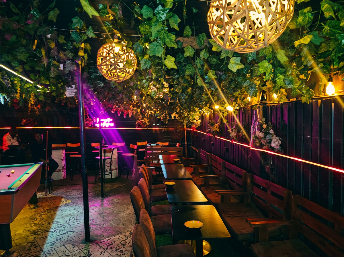 Inside Relish Lounge: pool table, lush hanging foliage and warm neon ambience